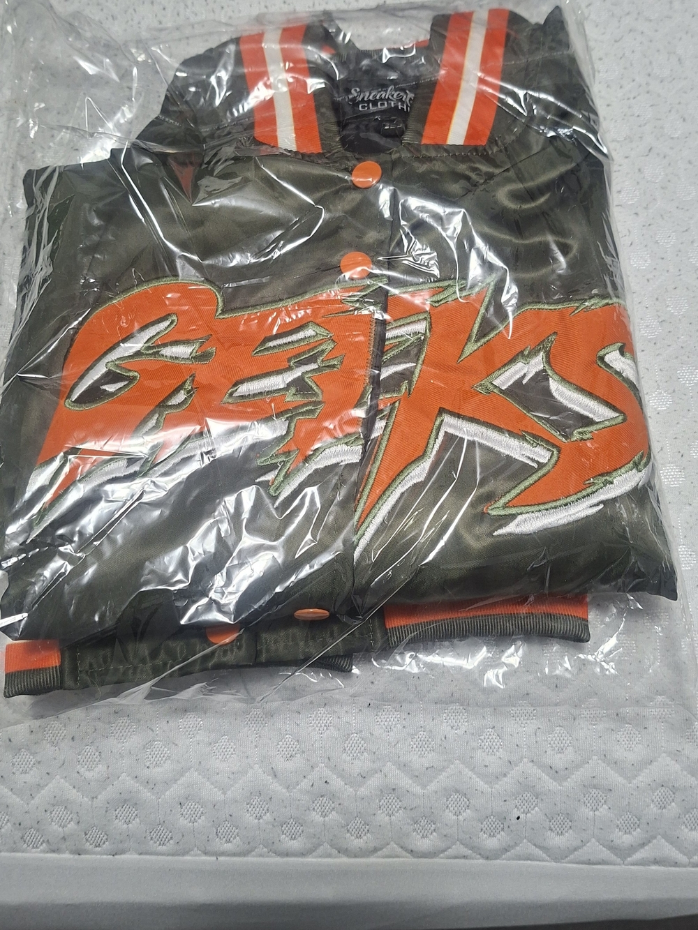 Olive Green Bomber Jacket with Bold Orange Patch Logo